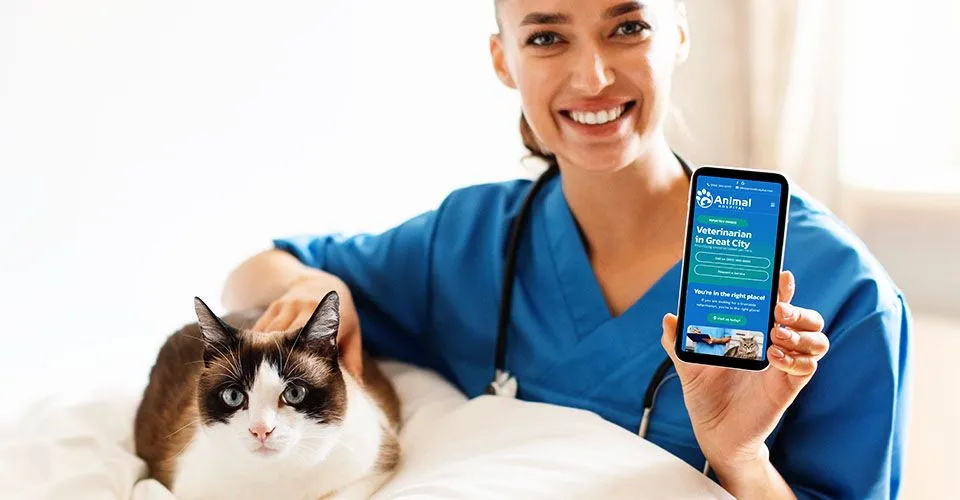 veterinarian with cat patient showing smartphone with website screen